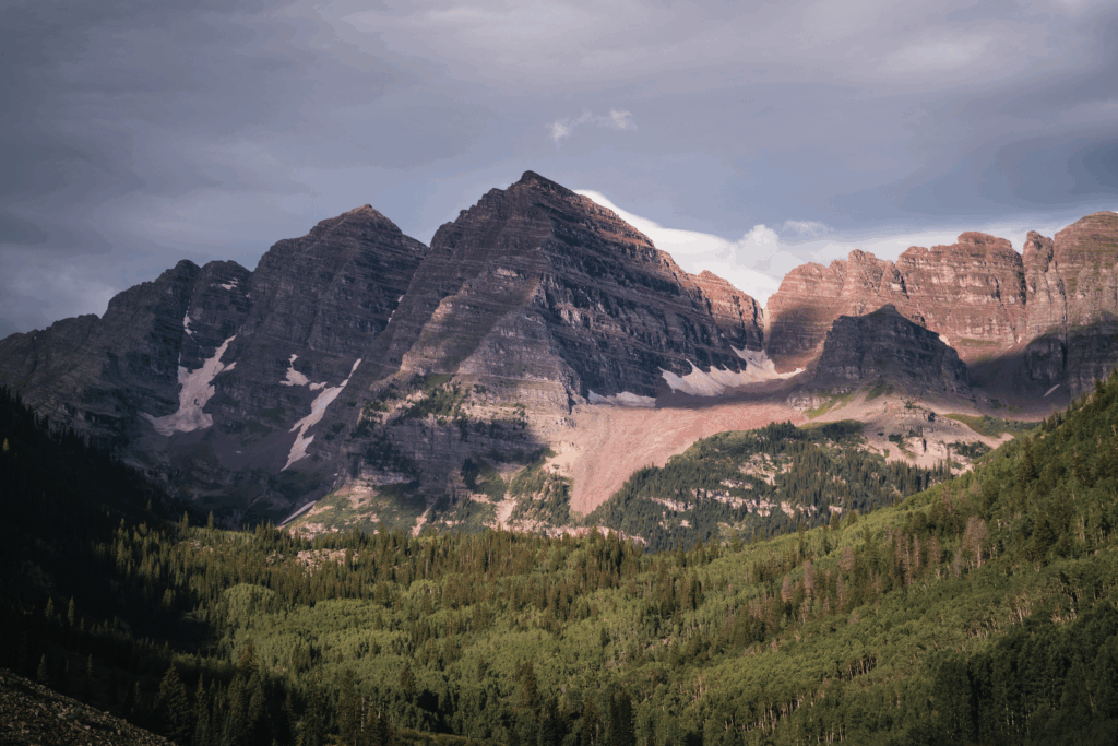 Jagged mountain peaks above a forested valley