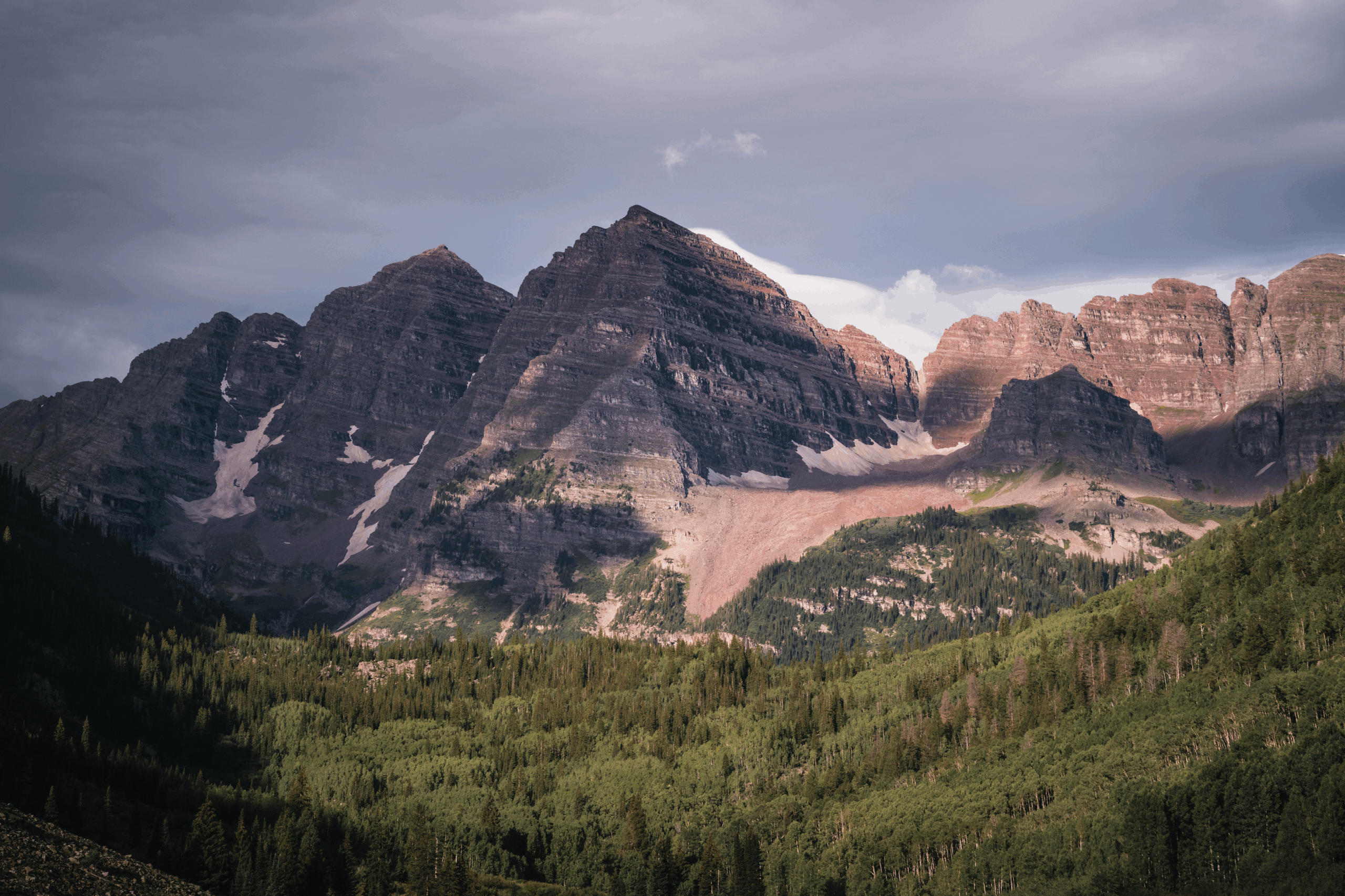 Couple exchanging vows at their Maroon Bells Aspen wedding ceremony at the amphitheater