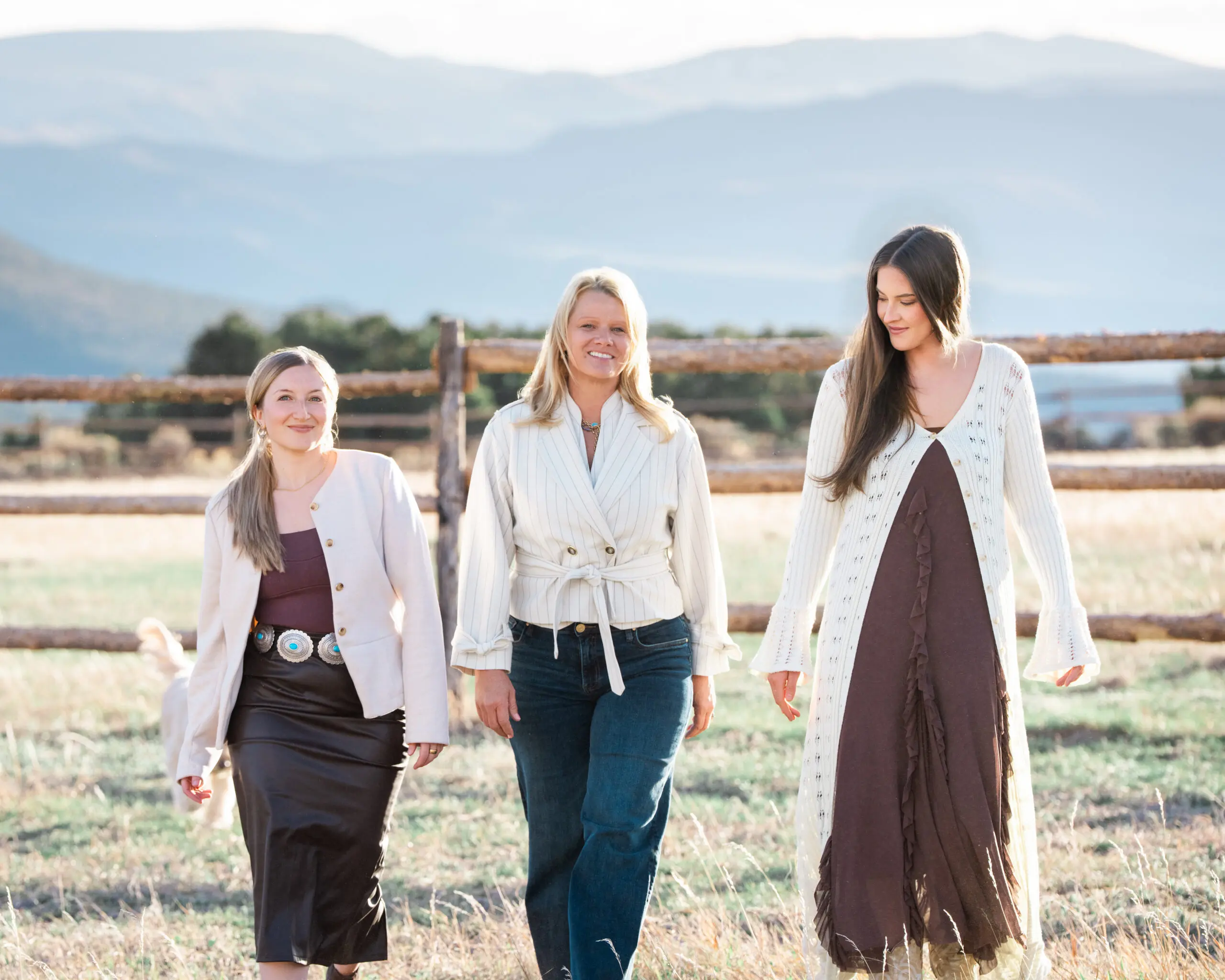 Three professionals walking together during an outdoor Aspen team photography session.