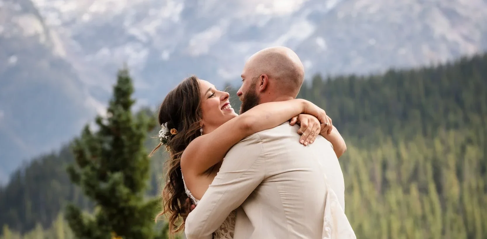 A newlywed couple sharing a joyful moment during an outdoor wedding Silverton Colorado with scenic mountain views.