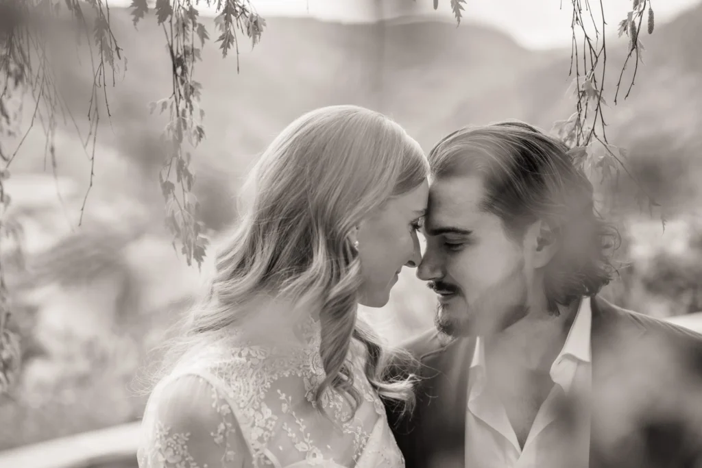 Close-up black and white portrait of a bride and groom touching foreheads during their Vail Colorado wedding, captured with soft natural light by Summit Photo and Film.