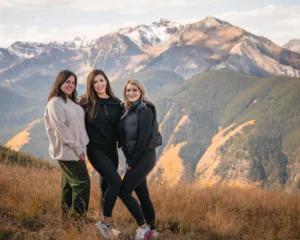 man wearing cowboy hat blows out candle on birthday cake