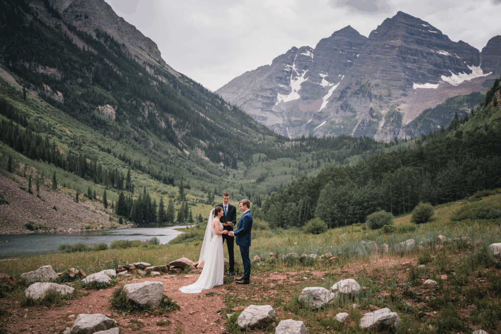 Intimate mountain wedding ceremony at Maroon Bells in Aspen, Colorado with stunning alpine views.
