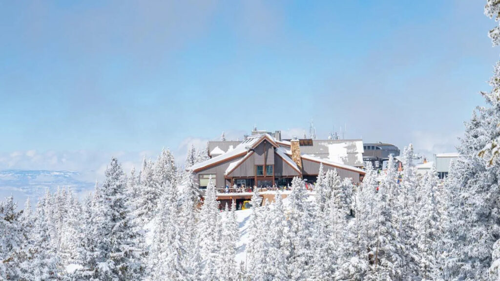 The Sundeck lodge wedding venue on Aspen Mountain, surrounded by snow-covered trees and stunning winter scenery.