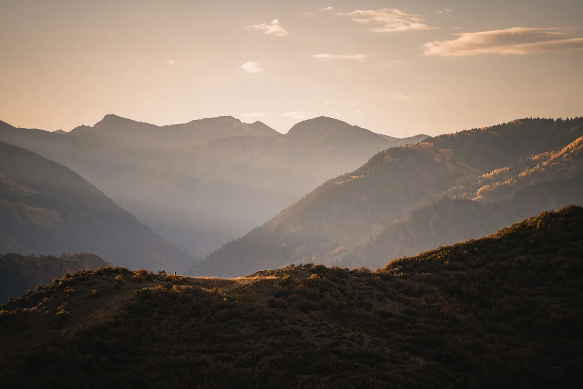 Layered mountain ridges at hazy sunset near Aspen
