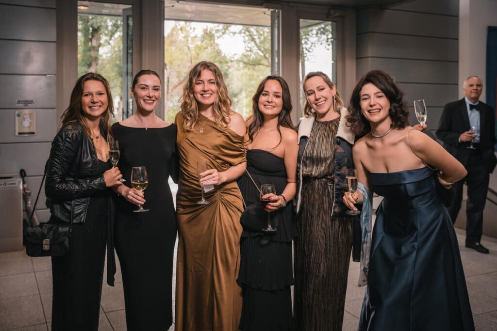 Group of guests smiling at a formal event captured with Instant Event Photography