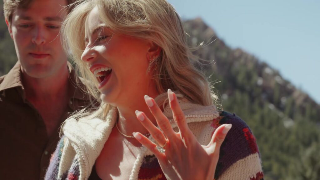 Close up reaction shot after surprise proposal on Hotel Jerome rooftop terrace in Aspen Colorado