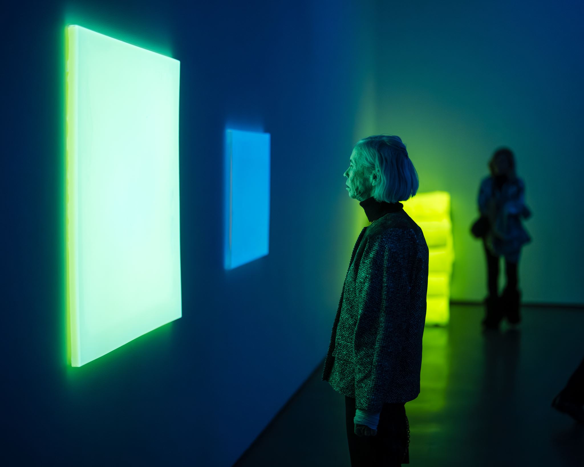 Guests talking in front of installed work during a December opening at the Aspen Art Museum